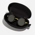 Black and gold goggles in a black case on a white background